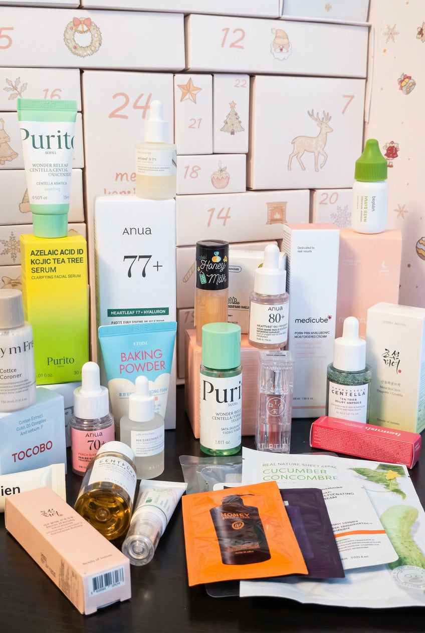 A collection of various skincare products from brands like Purito, Anua 77+, Medlab, and Tocobo, arranged on a black surface in front of a white advent calendar with Christmas illustrations.