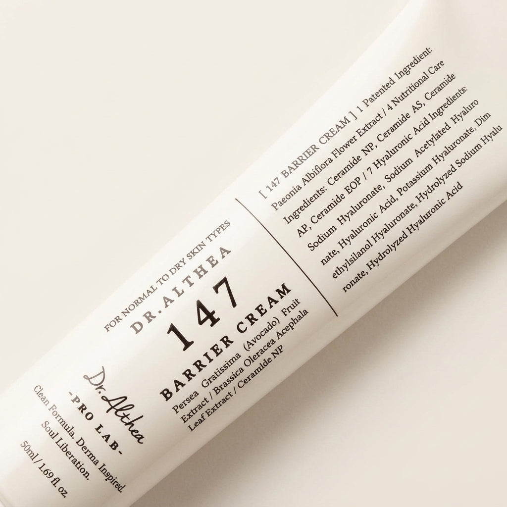 A close-up of a white tube of Dr. Althaea 147 Barrier Cream, angled diagonally against a dark black background.