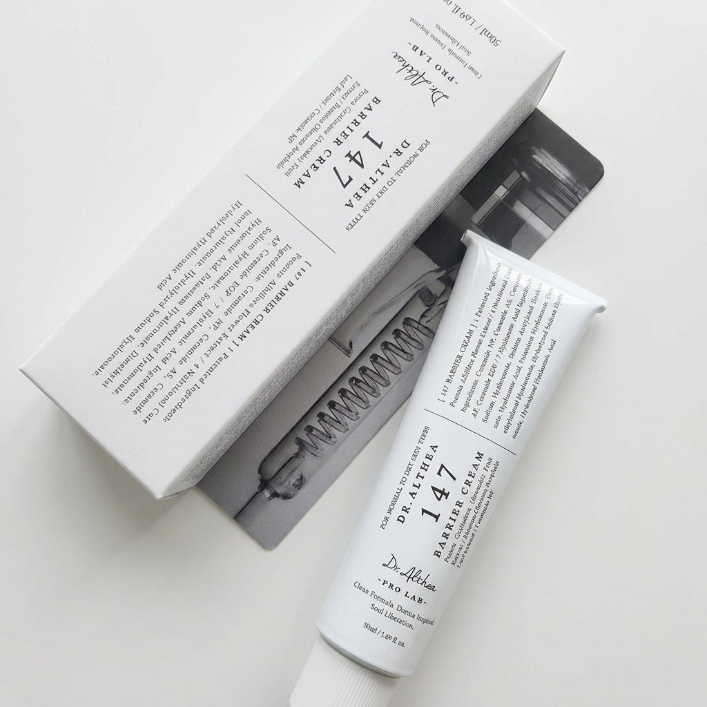 Dr. Althea 147 Cream 150ml tube and its white packaging box, displayed on a dark textured surface.